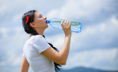  Young woman drinking water, outdoors