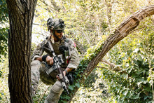 Soldier In Uniform Of The U.S. Army On The Trees