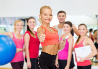 Sticker - smiling sporty woman with smartphone