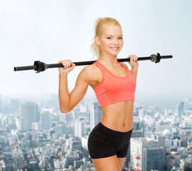 Canvas Print - smiling sporty woman exercising with barbell