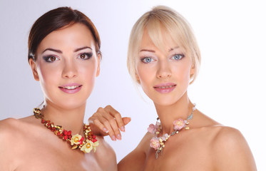 portrait of a two beautiful women with necklace, isolated on wh