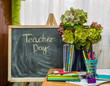 Teacher  Day. Hydrangea flowers and copybooks on the teacher d