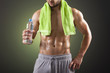 © cristovao31 - Fitness man holding a bottle of fresh water on black background