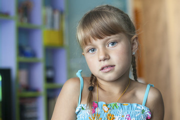 Portrait of little cute girl preoccupied in her room.