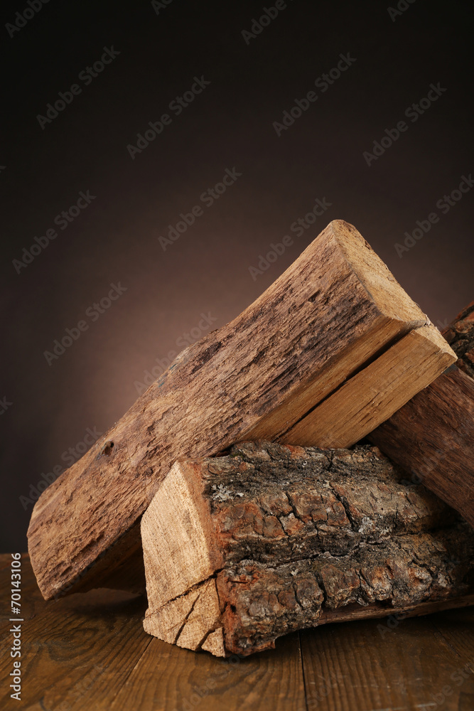 Heap of firewood on floor on dark background