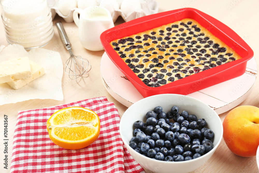 Baking tasty pie and ingredients for it on table in kitchen