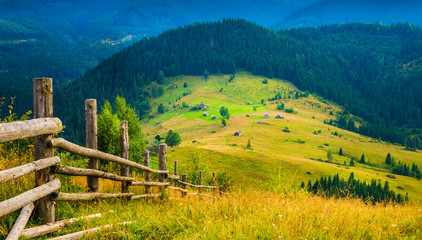 Wall Mural - amazing mountain landscape with fog and a haystack