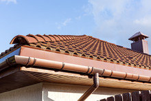 Red Tiled Roof With Gutter And Chimney
