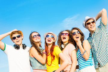 Wall Mural - group of young people wearing sunglasses and hat