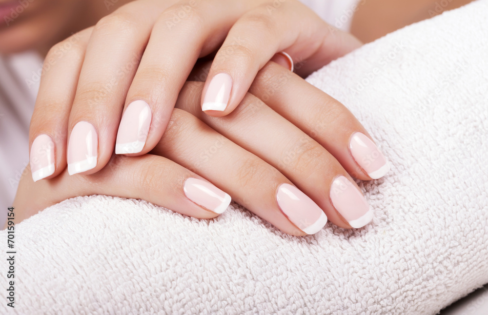 Beautiful woman's nails with french manicure. - obrazy, fototapety, plakaty 