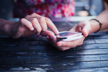 Woman using her smart phone outside