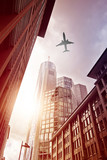 Fototapeta Nowy Jork - plane over office district
