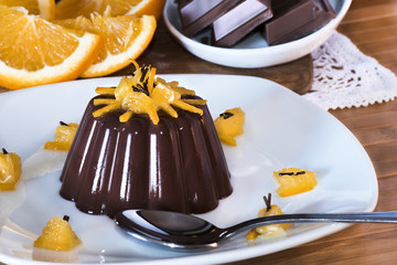 Delicious chocolate dessert with orange slices on sunrise light