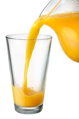 Wall Mural - Orange juice is poured from pitcher into the glass