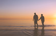 Senior couple walking at sunset