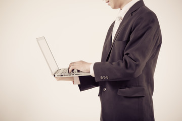 Asian business man using laptop computer isolated on white backg