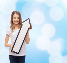 Canvas Print - smiling little girl with blank arrow pointing up