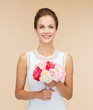 © Syda Productions - smiling woman in white dress with bouquet of roses