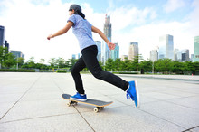 Woman Skateboarding At City