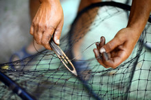 Repairing A Fishing Net