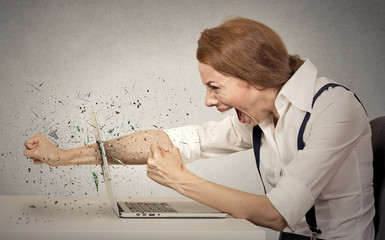 Furious businesswoman throws punch into computer, screaming