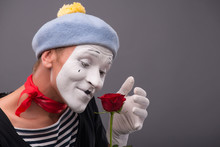Waist-up Portrait Of Young Male Mime Holding A Flower Isolated O