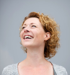 Wall Mural - Close up portrait of a cheerful woman laughing