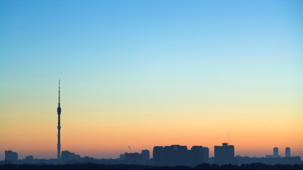 Wall Mural - clear blue and yellow dawning sky over city