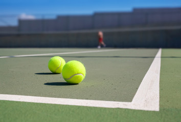 two tennis ball near baseline