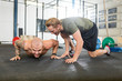Trainer Motivating Man In Doing Pushups