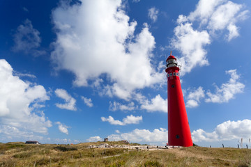 Fototapete - red lighthouse oer blue sky