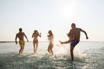 Wall Mural - happy friends having fun on summer beach