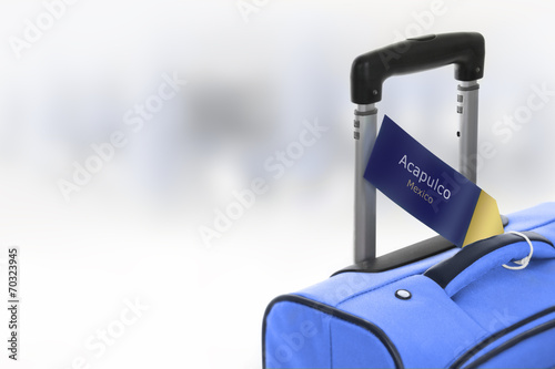 Fotografija Acapulco, Mexico. Blue suitcase with label at airport.