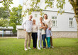 © Syda Productions - happy family in front of house outdoors