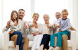 © Syda Productions - happy family sitting on couch at home