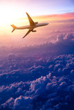 Fototapeta Góry - Airplane in the sky at sunrise