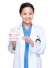 Sticker - Dentist hold with denture and toothbrush