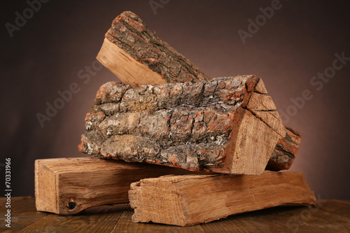 Fotografía Heap of firewood on floor on dark background