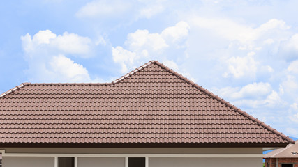 roof under construction with stacks of roof tiles for home build