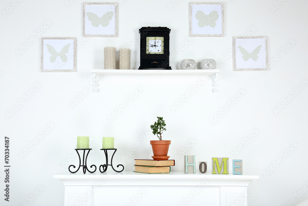 Different objects on white shelf in living room