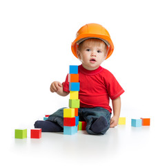 little kid in hard hat with building blocks