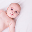 © ctvvelve - baby laying on white sheets in bed