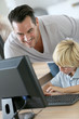 © goodluz - Teacher with school boy in computers's lab