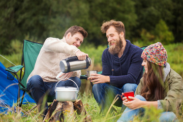 Canvas Print - group of smiling friends cooking food outdoors