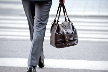 Man in suit with bag, on zebra crossing