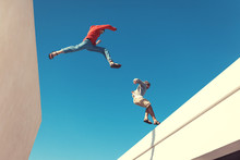 Two Brave Men Jumping Over The Roof, And Little Motion Blur