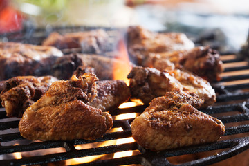 Wall Mural - Grilling chicken wings on barbecue grill