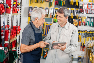 Wall Mural - Salesman With Customer Using Digital Tablet In Store