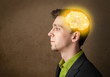 © ra2 studio - Young man thinking with glowing brain illustration