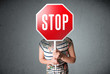 Young woman holding a stop sign